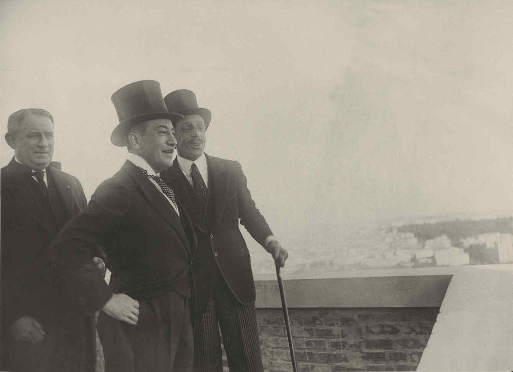 Madrid. H.M. the King, Marqués de Urquijo and Mr. Proctor contemplating the panorama of Madrid from one of the upper floors of the new building on Gran Vía.