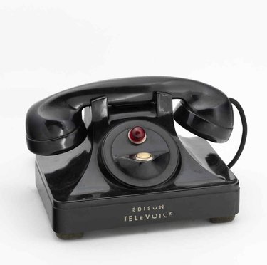 Telephone set made of black Bakelite by Thomas Alba Edison Inc. This equipment was advertised for offices. When the handset was lifted, communication was established with the secretary, who could be dictated to as desired.