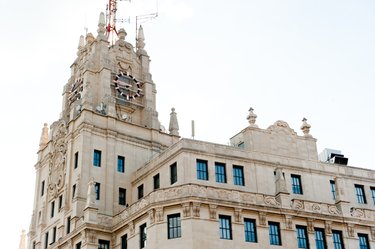 THE CLOCK ON THE TOWER OF THE GRAN VÍA BUILDING CHANGES ITS COLOUR FROM RED TO CORPORATE BLUE