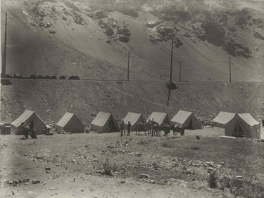 The Transandine Telephone Cable. The camp at Caracoles, Chile. Above can be seen reels of cable ready to be taken by truck and by hand to the new line.  The Transandine Telephone Cable. The camp at Caracoles, Chile. Next to the railway lines can be seen